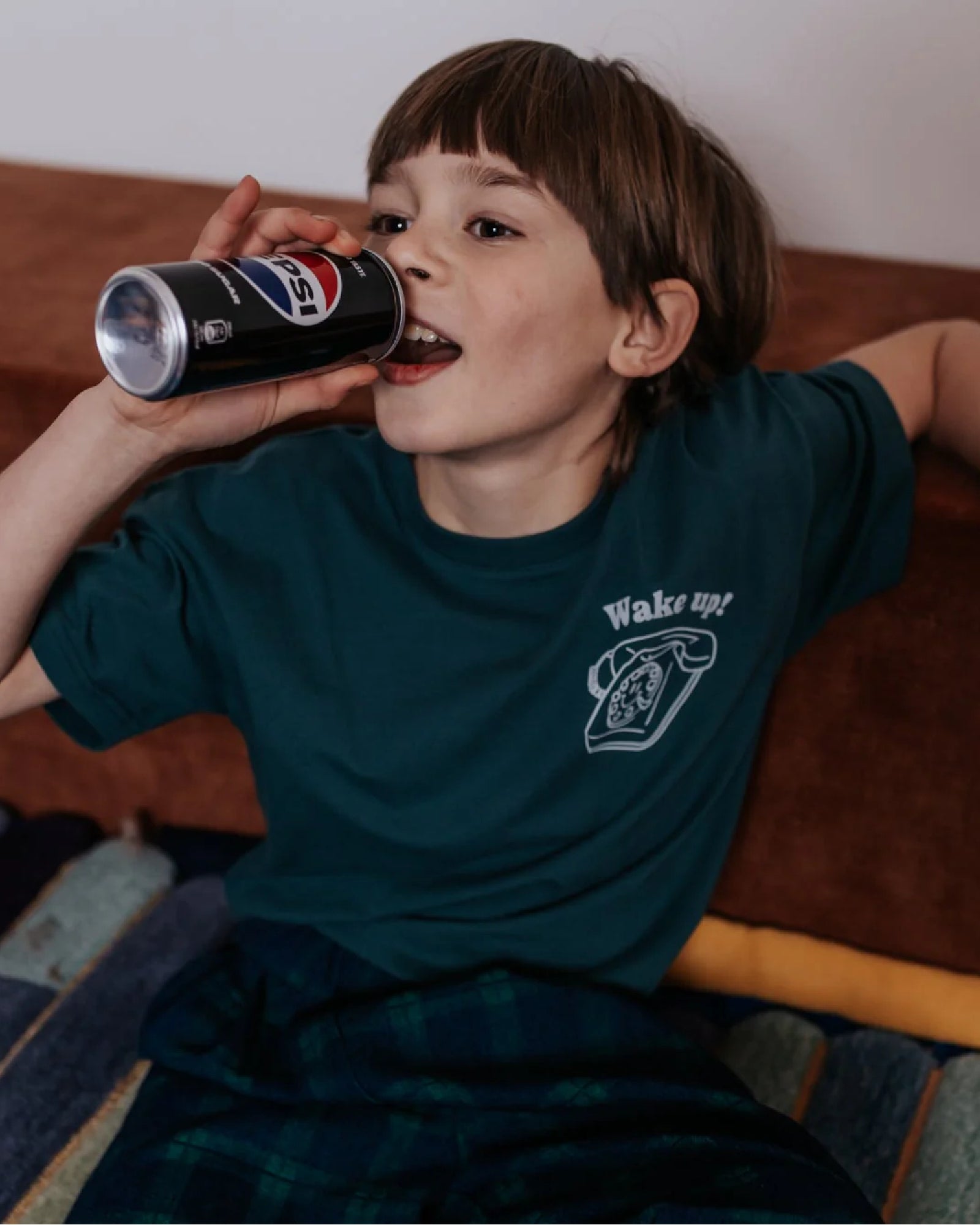 boy model wearing the wake up t-shirt in moss 