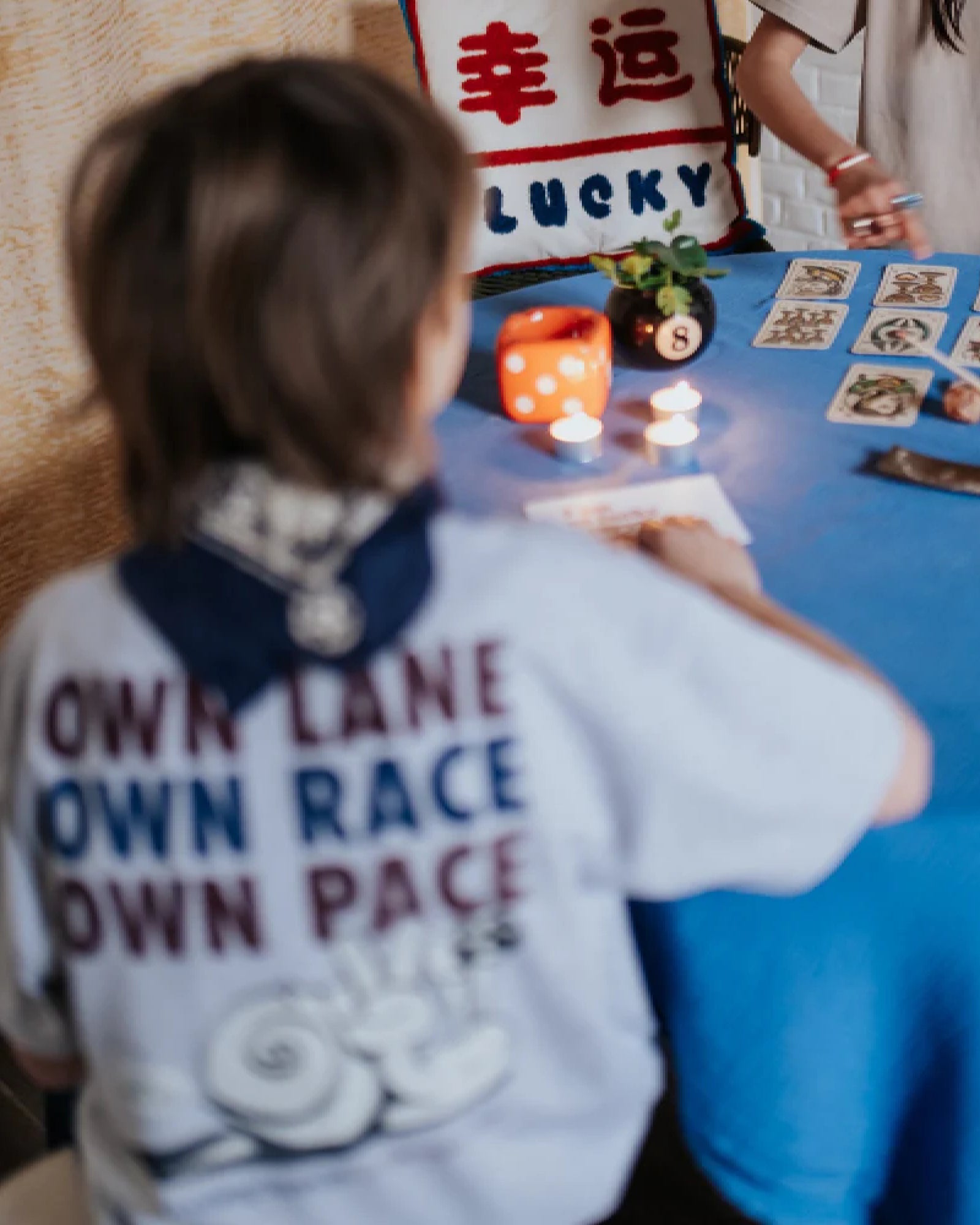 boy model showing the own lane t-shirt in grey melange from the back and it says own lane, own race, own pace with a graphic of a snail