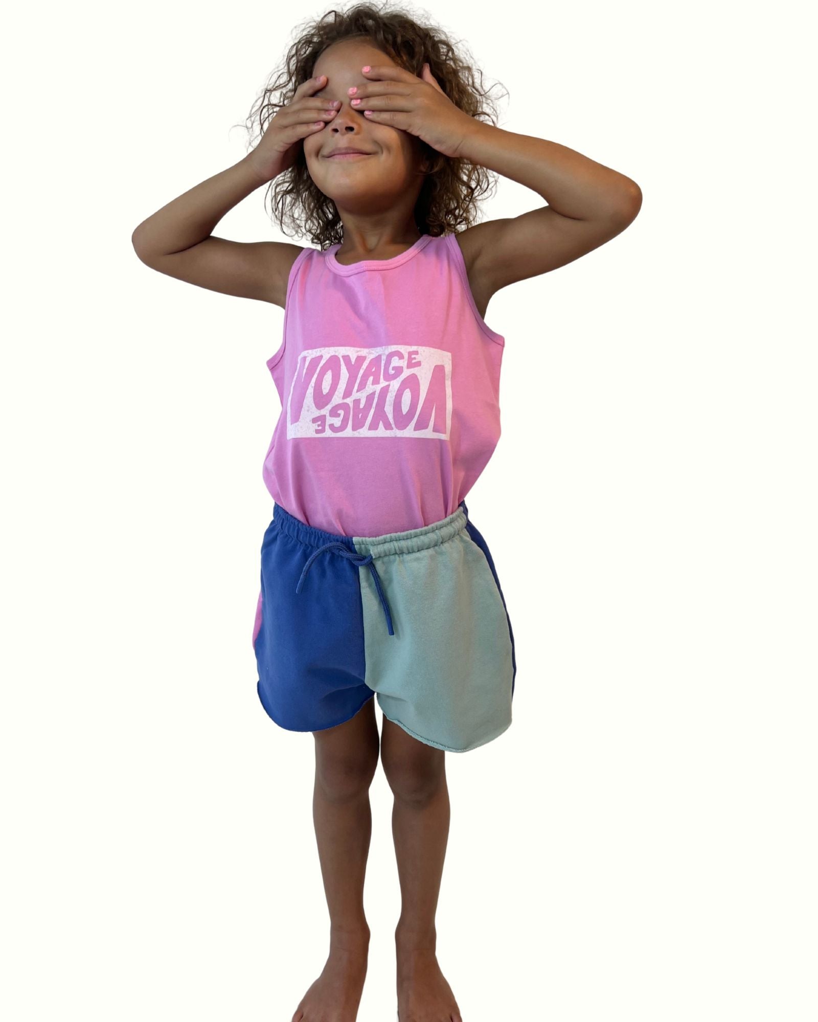 girl model wearing the voyage tank top by Cos I Said So with the matching cut off jog shorts colorblock 