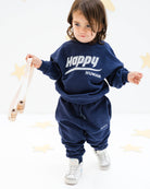 2-year-old boy wearing the happy human sweater and matching jog pants in maritime navy blue from Cos I Said So