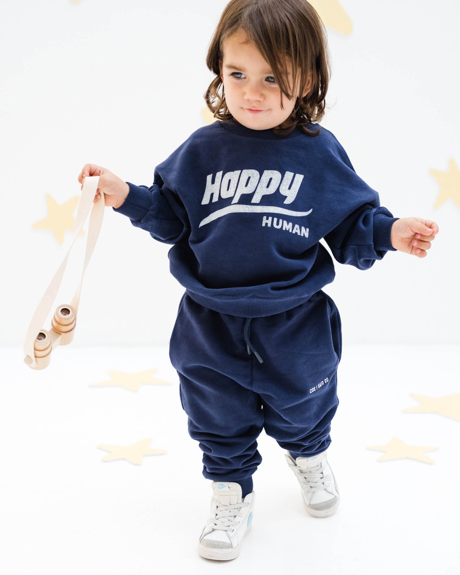 2-year-old boy wearing the happy human sweater and matching jog pants in maritime navy blue from Cos I Said So