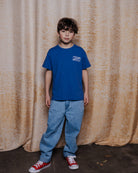 boy model wearing the voyage t-shirt in ultramarine blue in high quality organic cotton