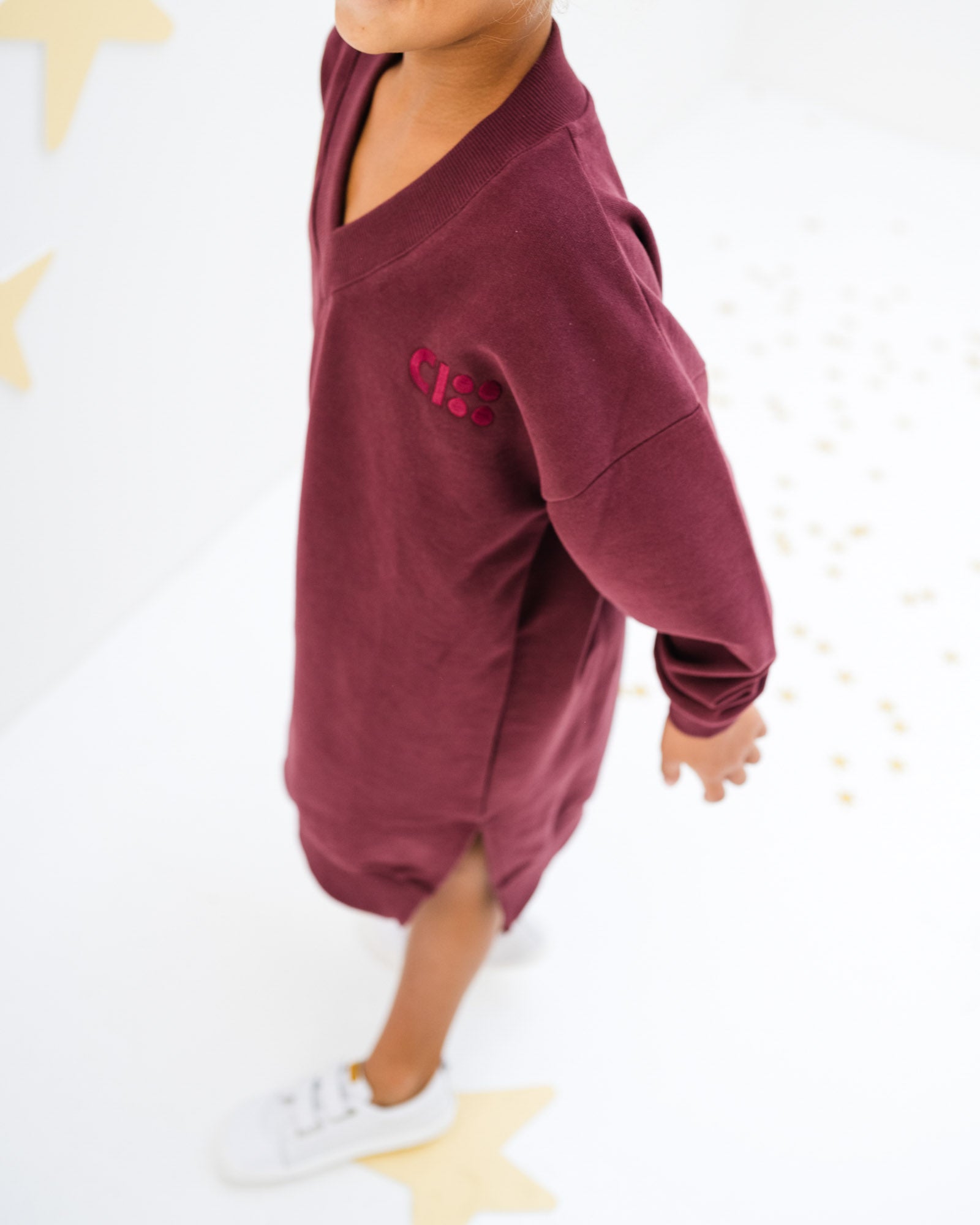 7-year-old girl wearing the V-neck dress in port from Cos I Said So, showing CISS embroidery in front