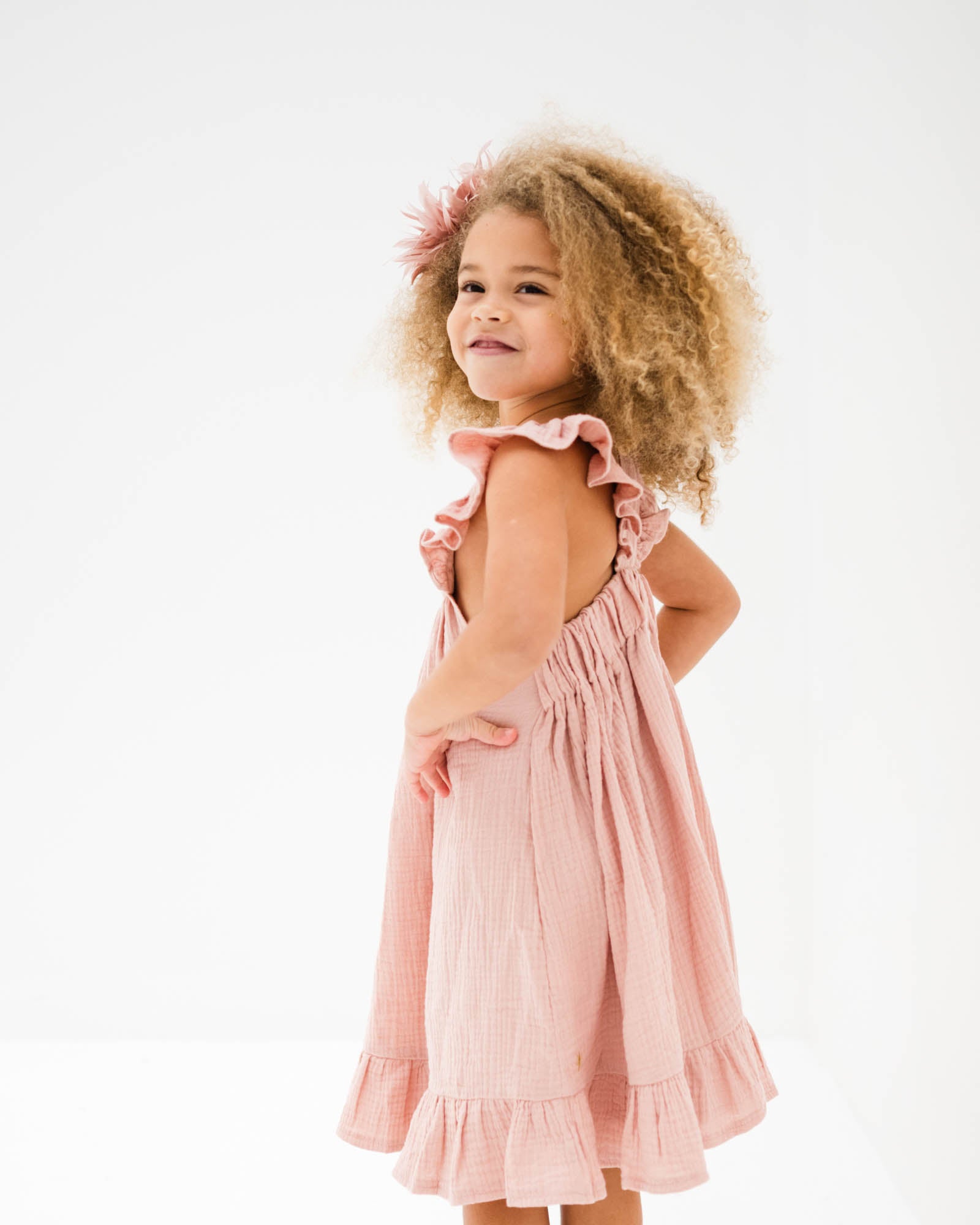 girl model showing the side of the river dress in soft pink muslin cotton