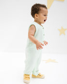 baby boy wearing the lois onesie in mint muslin cotton