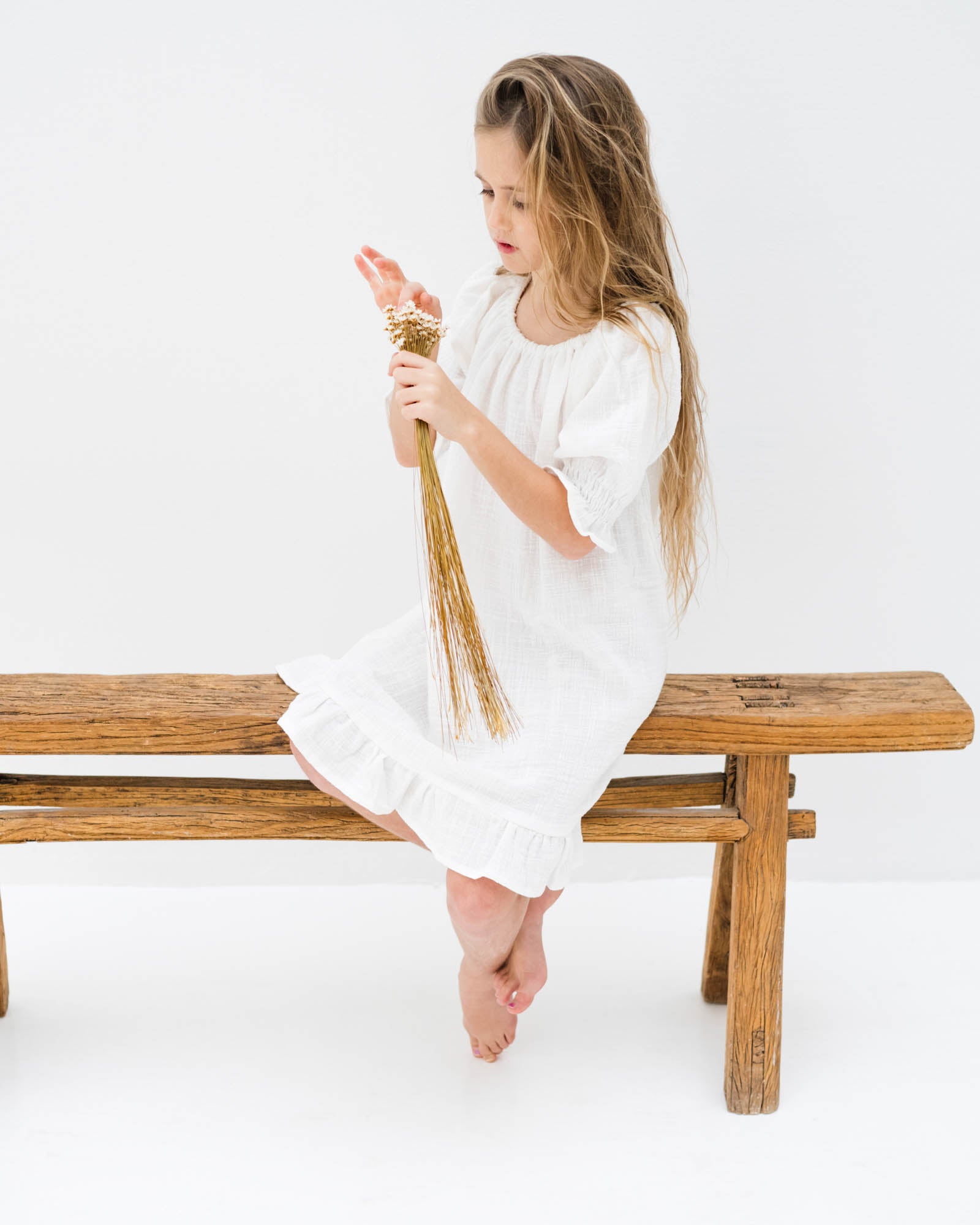 girl model wearing the Alexa dress in white linen muslin cotton