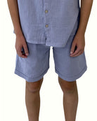 boy model wearing the boys shorts Julian by Les Vedettes in high quality muslin cotton in the color cloudy blue