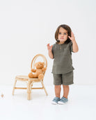 2-year-old bou wearing the Charlie shirt with the Julian shorts in khaki green
