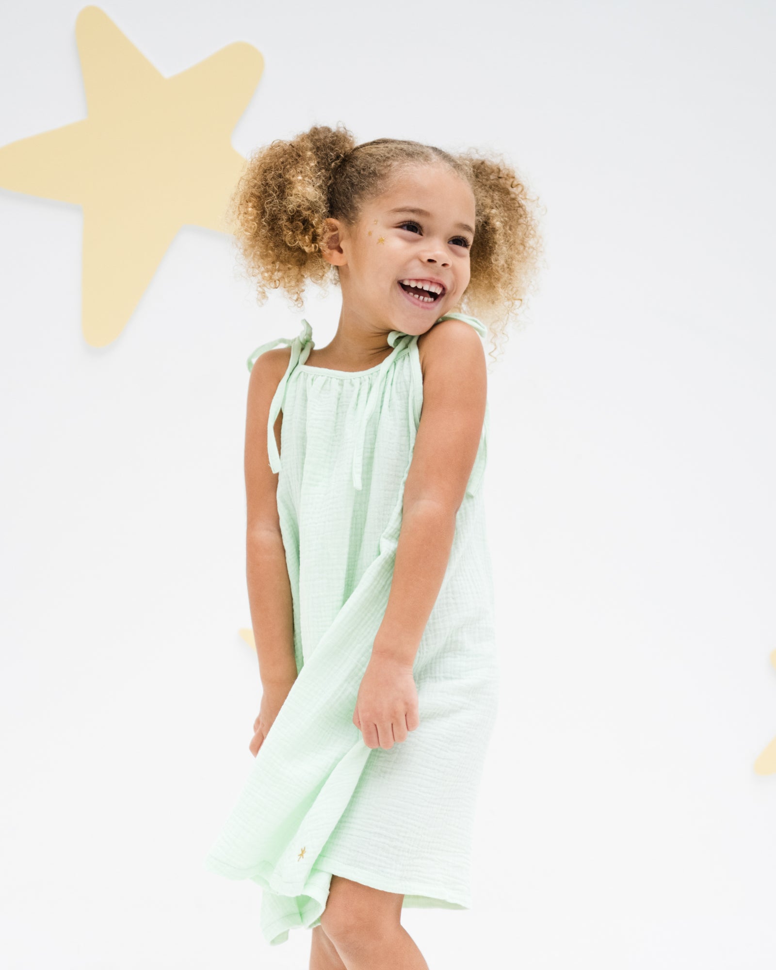 girl model wearing the romy dress in soft mint muslin cotton