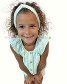 girl model showing the Lilou shirt in mint by Les Vedettes with matching twisted headband in mint