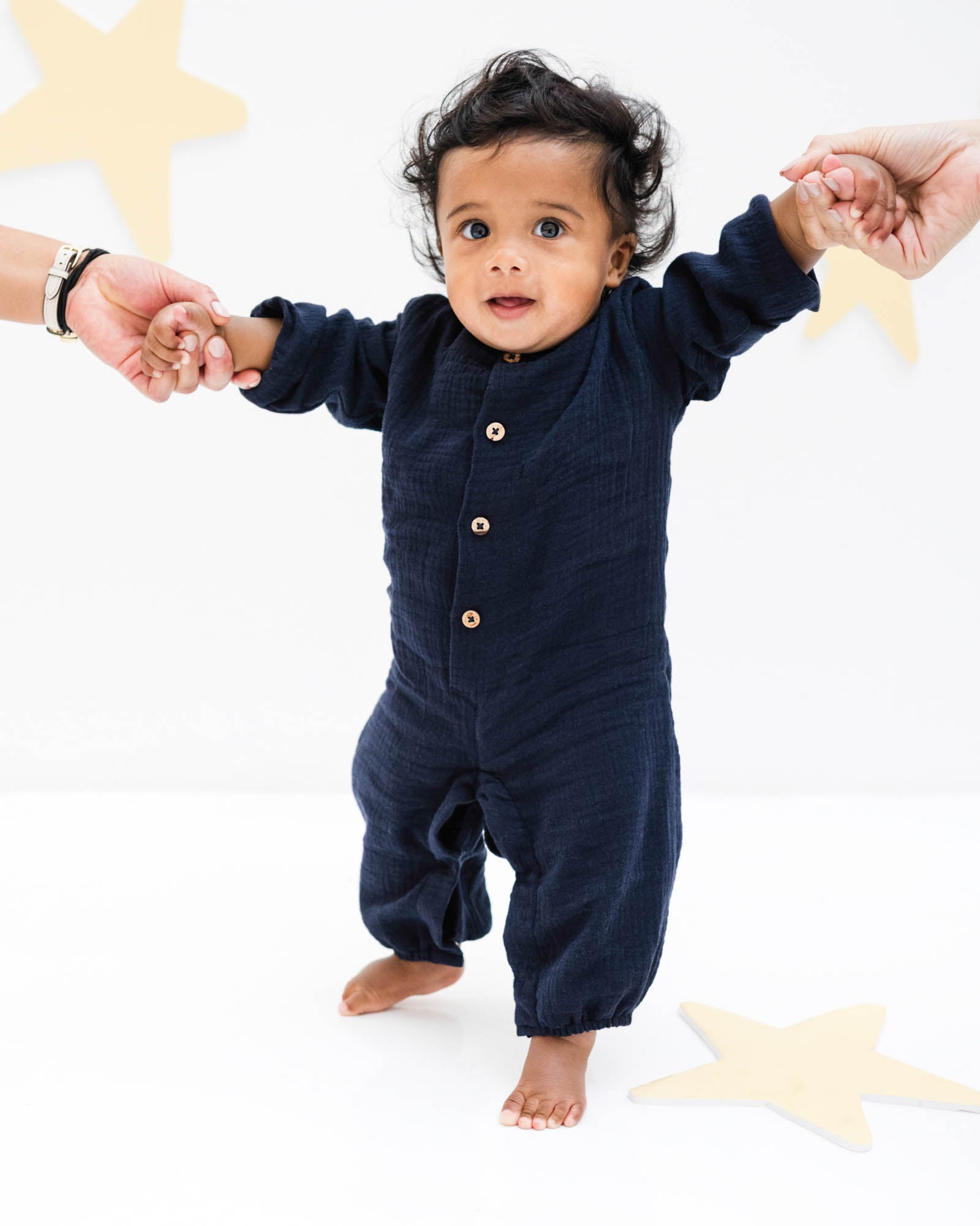 baby boy wearing the leo onesie with long sleeves in night blue muslin cotton