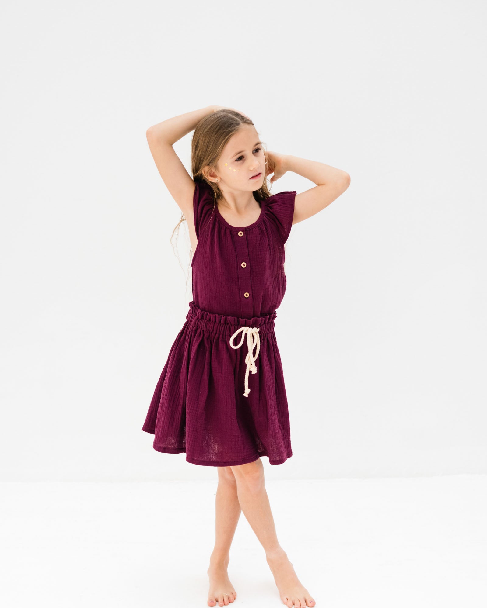 girl model wearing the Lilou top with matching Sienna skirt in aubergine