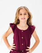 girl model showing the Lilou top in aubergine