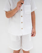 5-year-old boy wearing the raphael shirt with matching julian shorts in white