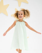 girl model wearing the romy dress in soft mint muslin cotton
