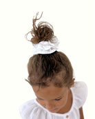 girl model showing the scrunchie by Les Vedettes in white muslin cotton