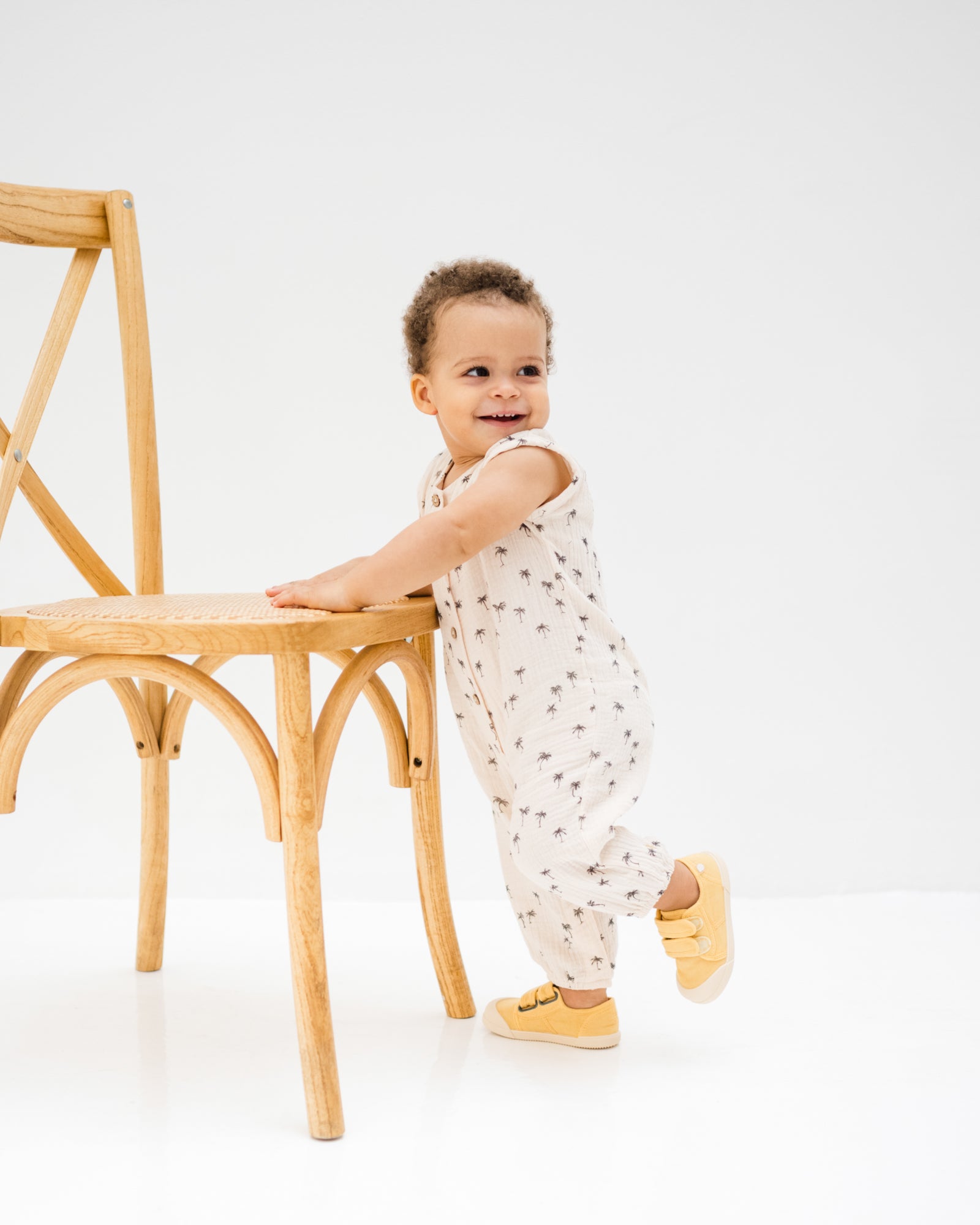 baby boy showing the lois onesie palms from the side