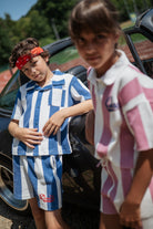 Two children in matching striped outfits 